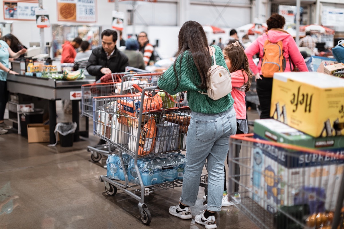 Tigard, Oregon - Nov 8, 2019 : People with carts in Costco Wholesale. Costco is an American multinational corporation which operates a chain of membership only