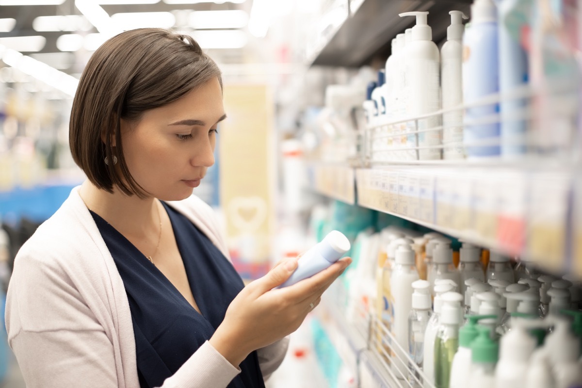 woman buying sunscreen at drugstore