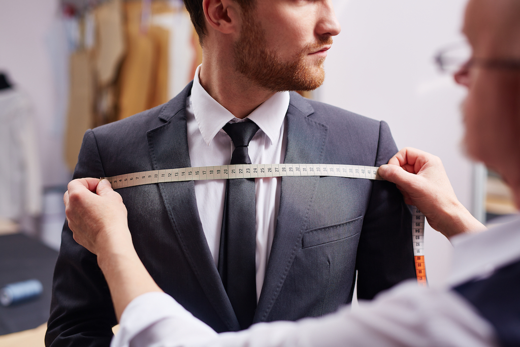 man getting measured at a store, how to dress over 40