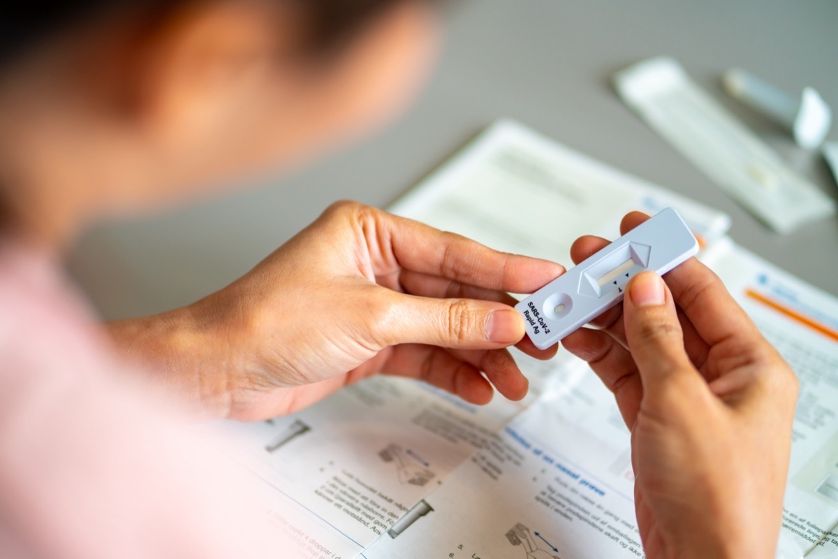 woman looking at covid rapid test