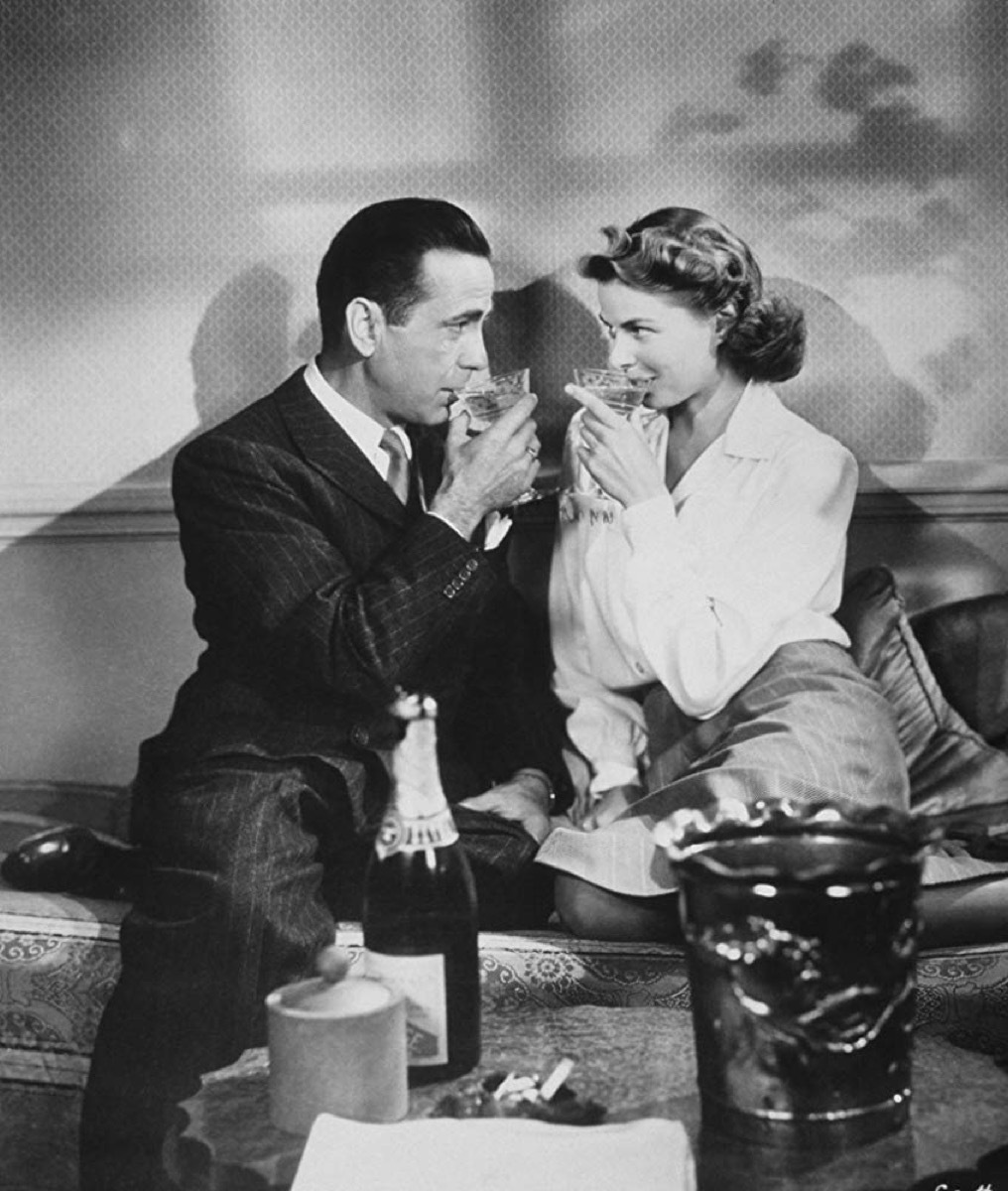 Ingrid Bergman and Humphrey Bogart sharing a drink in Casablanca