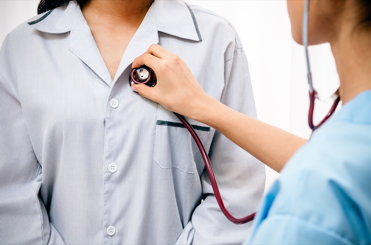 Health care worker listening to patient's heart during coronavirus pandemic