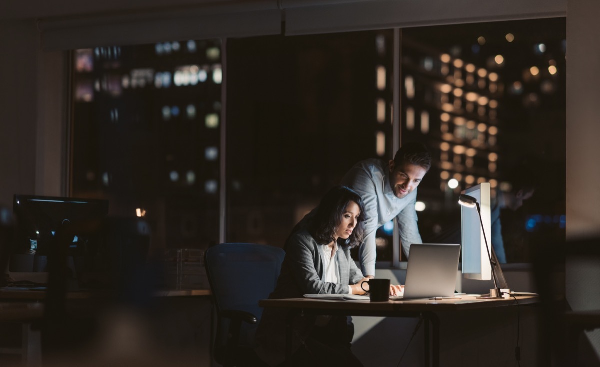 man and woman working late at the office