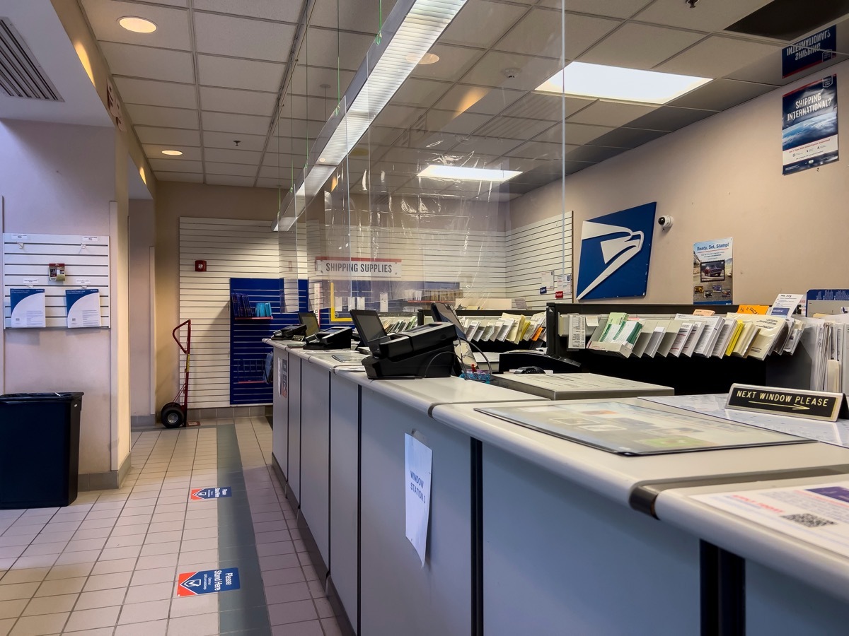 Angled, selective focus on the front desk counter inside a USPS office.