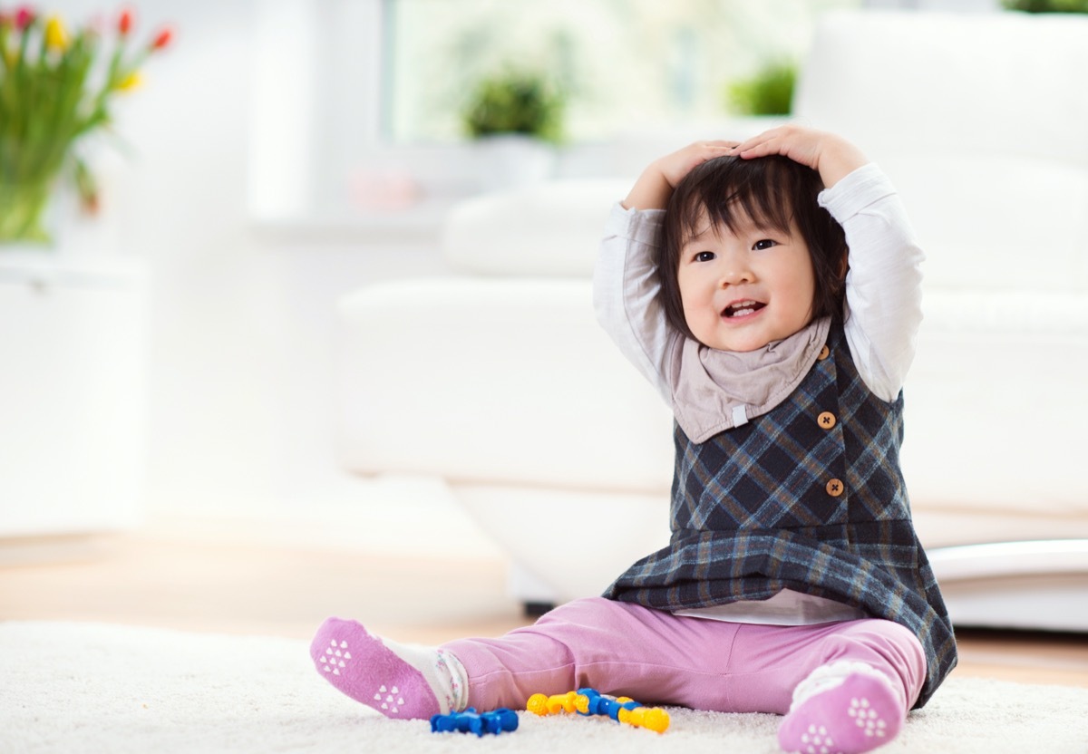 Asian baby girl playing on floor