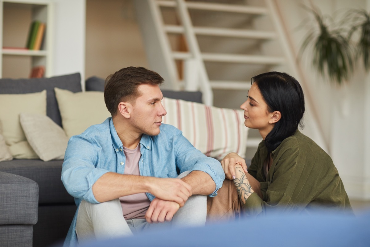 Couple sitting on the floor talking together