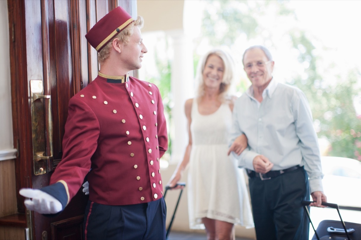 Older couple walking into hotel