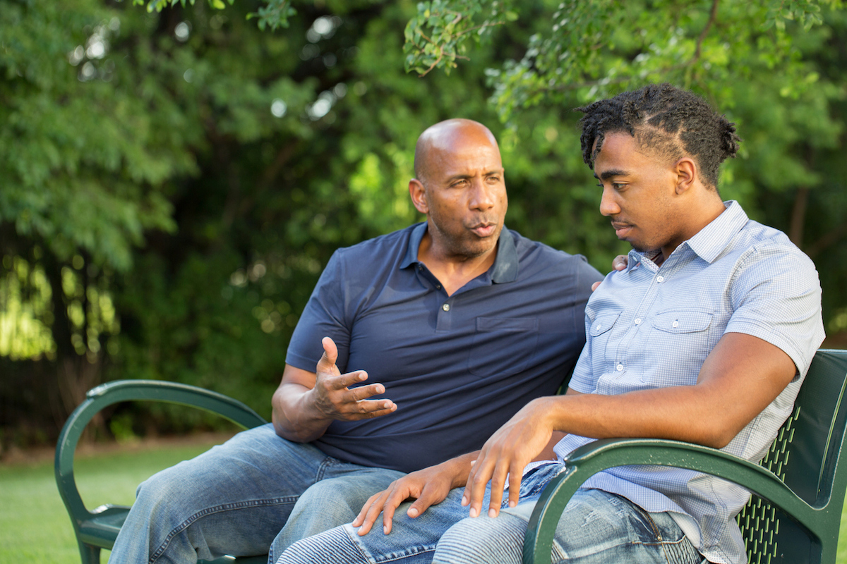 Father mentoring and giving advice to a younger man.