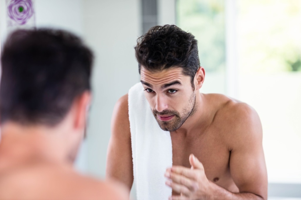 shirtless man in mirror