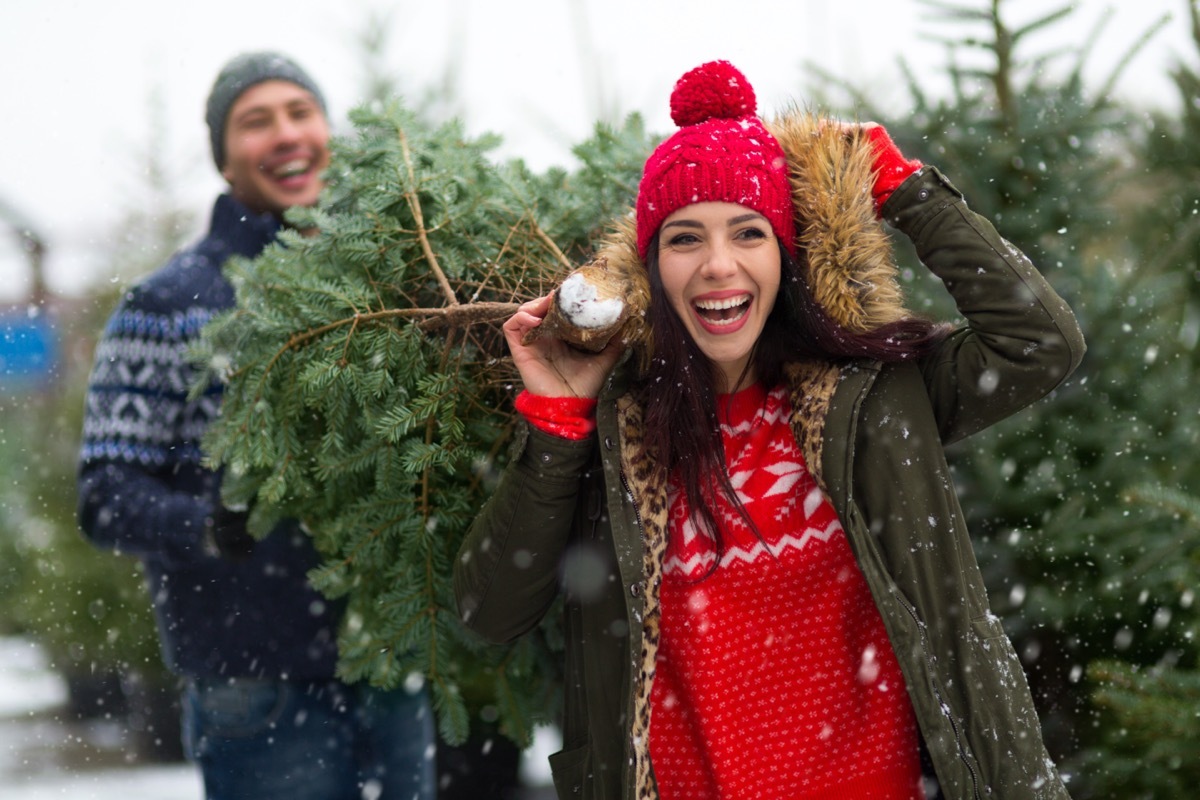 Young couple buying Christmas tree