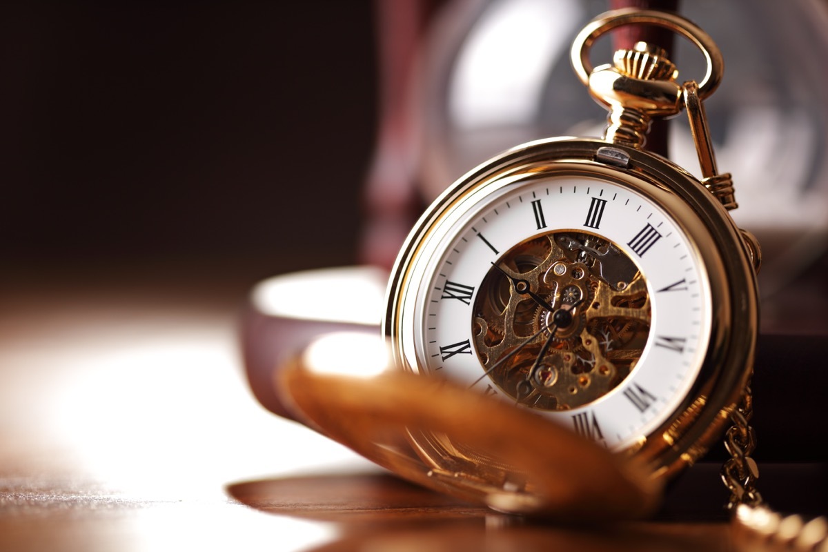 an old pocket watch propped open, titanic artifacts