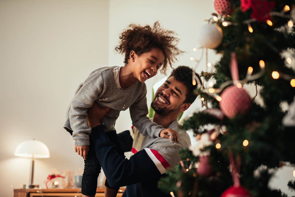 Shot of an african american father and daughter celebrating Christmas with love at home.