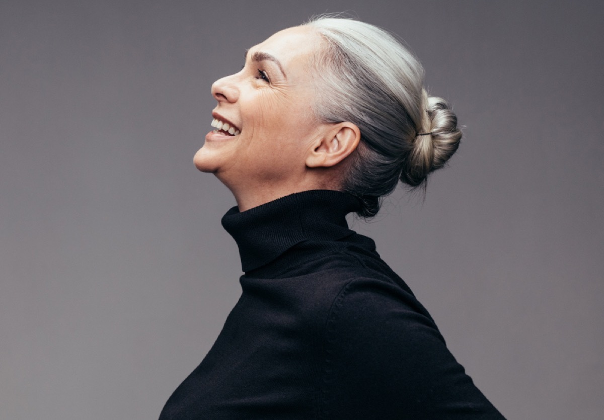 profile of smilling woman with gray hair pulled back