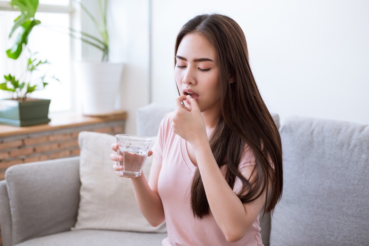 young woman taking supplement