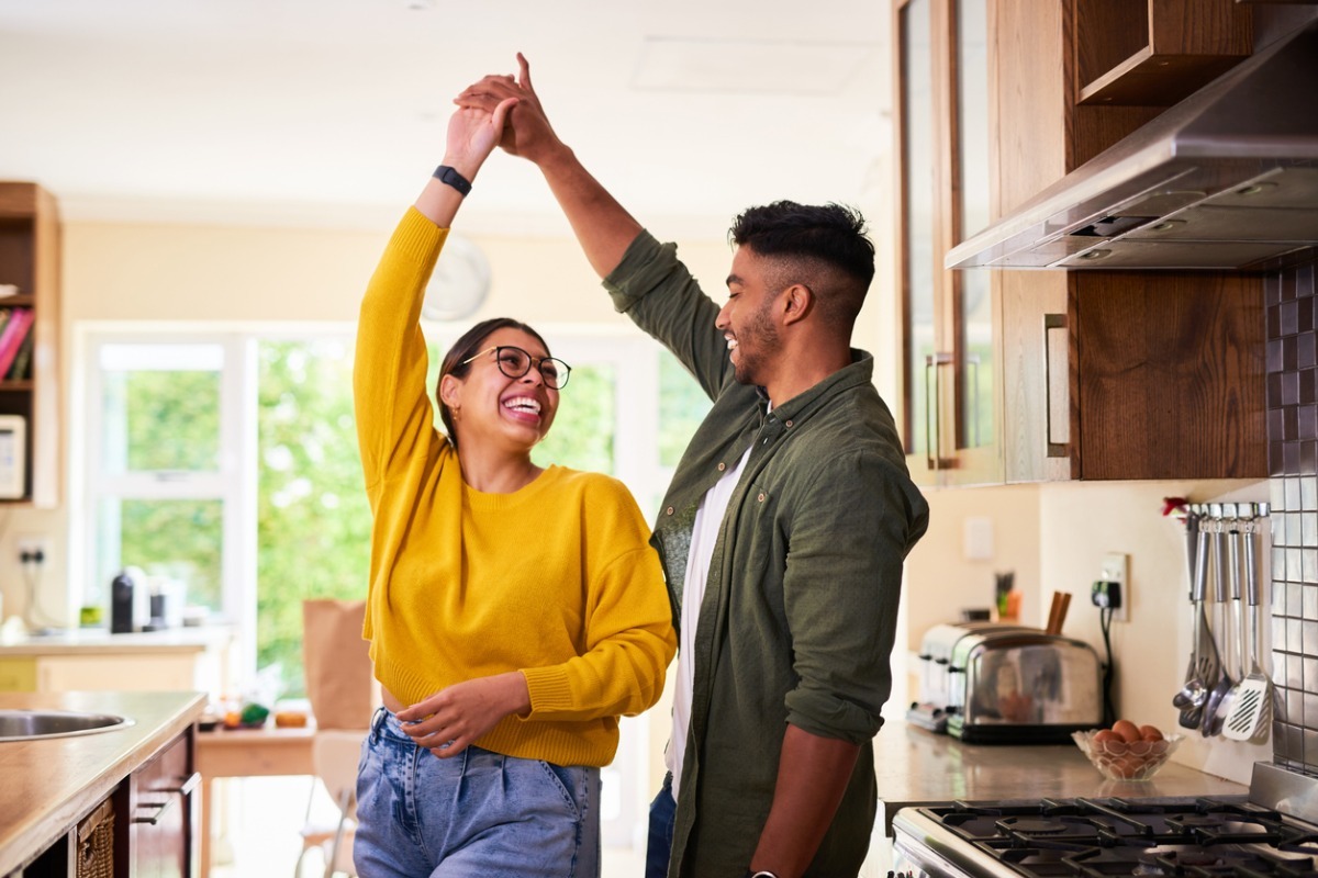 a couple dancing in a kitchen