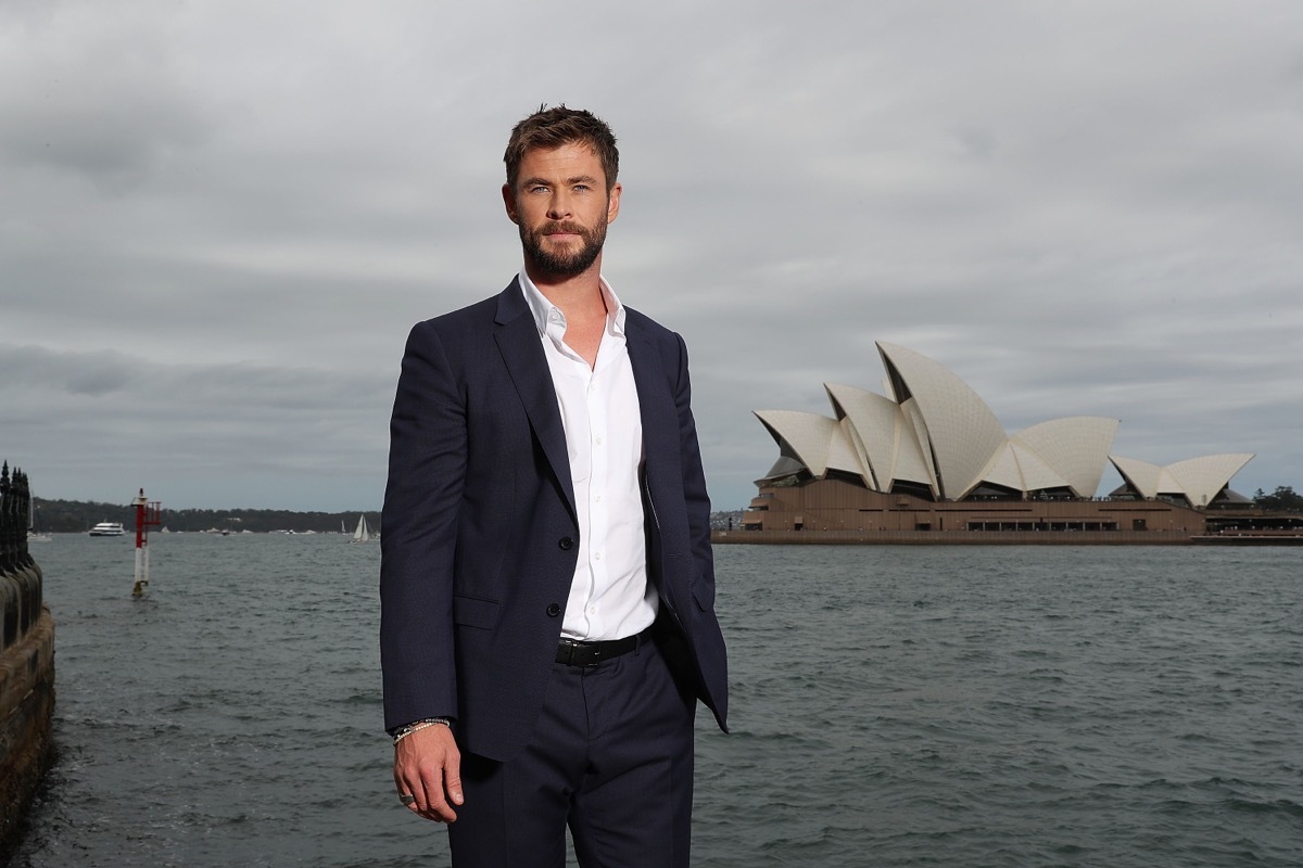 chris hemsworth standing in front of sydney opera house