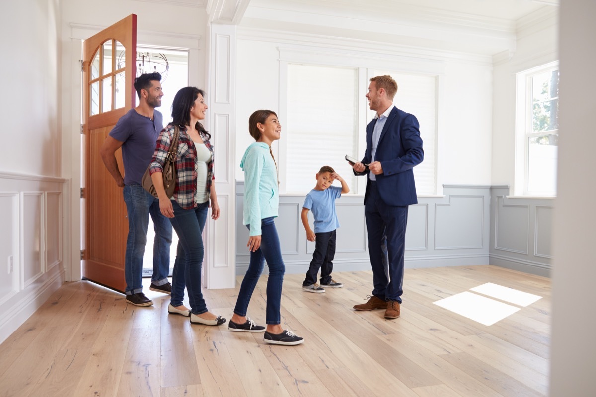 Real Estate Agent Showing a Family a House {Cons of Owning a Big House}