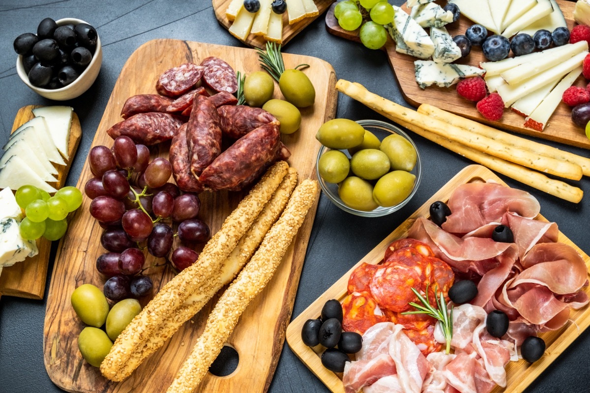 charcuterie board with sesame seed breadsticks