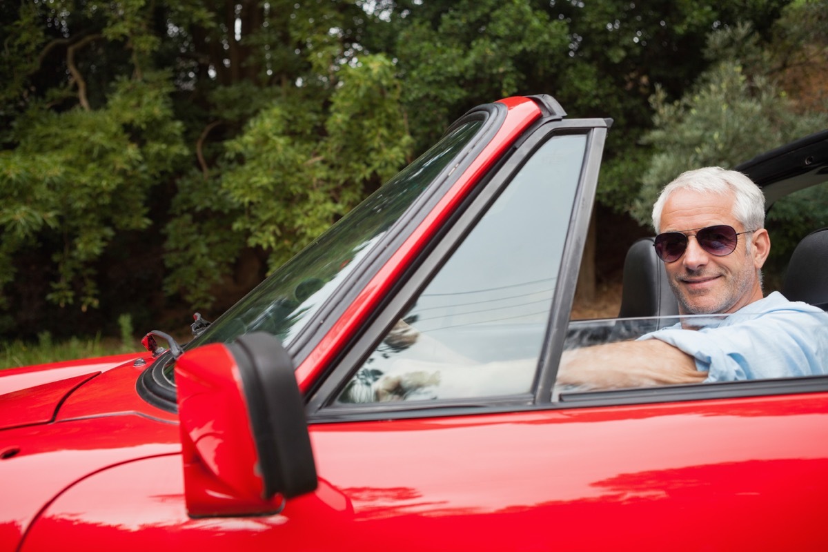 Older man driving a convertible