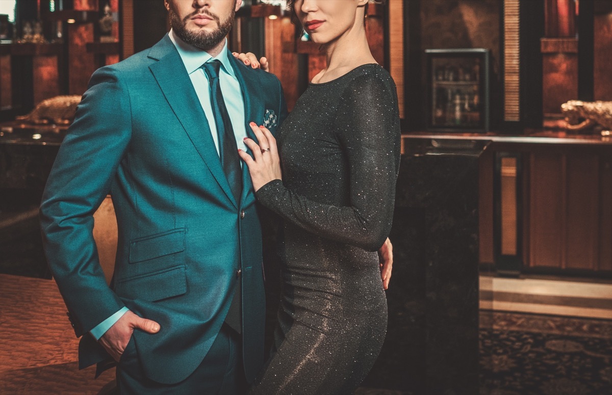 man in a fancy suit with a woman in a fancy cocktail dress