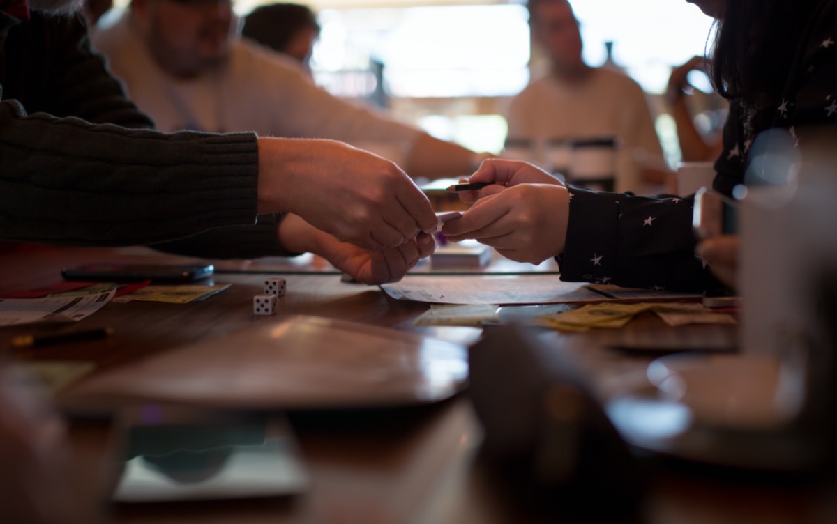 friends handing cards to each other