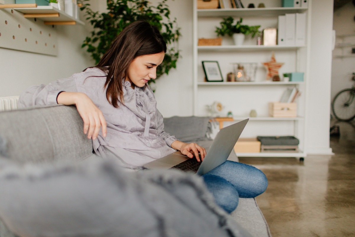 Young woman using computer at home