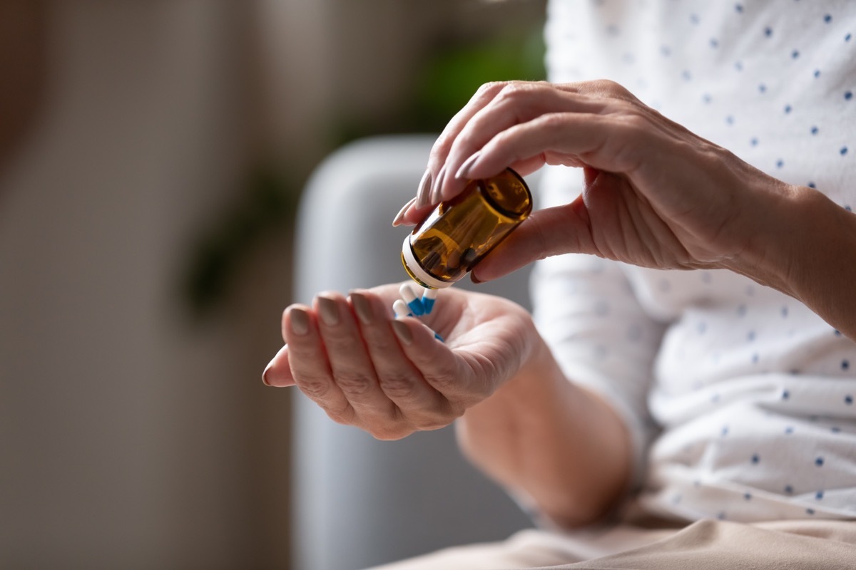 woman pouring antibiotics into her hand