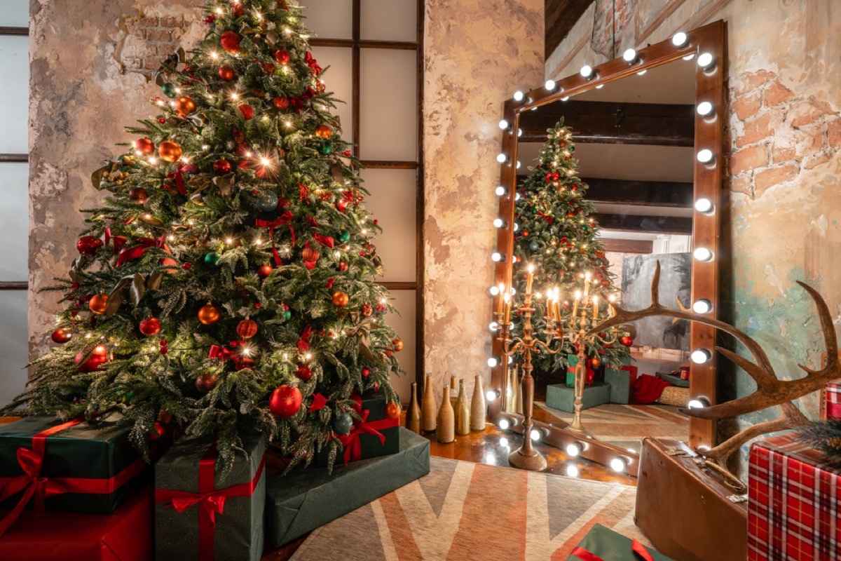 christmas tree in loft decorated in red and gold ornaments with matching wrapping paper 