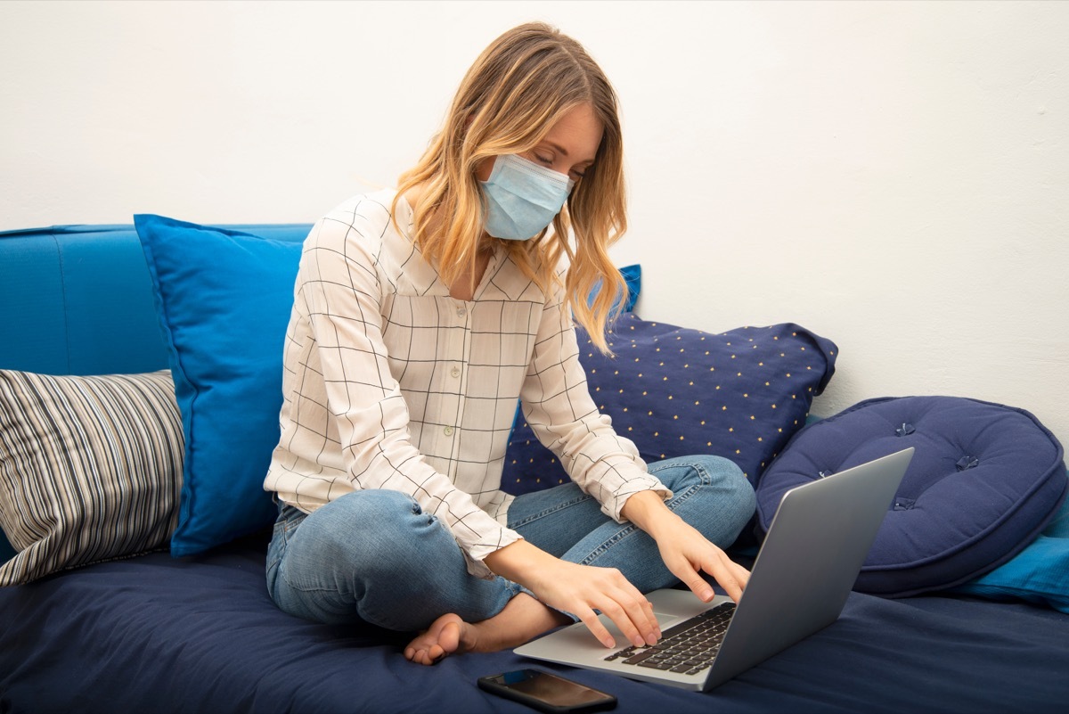 young white woman working from home wearing mask