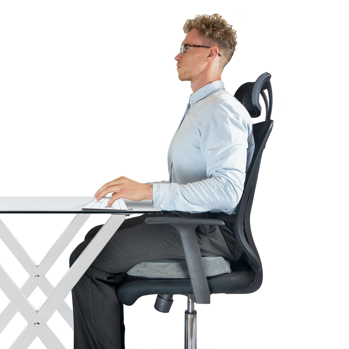 Male sitting on office chair at desk with good posture and support