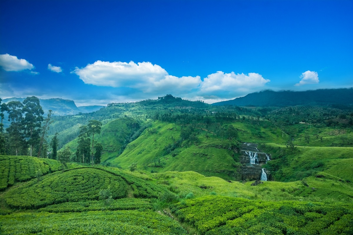 green valley, waterfalls, and blue sky in sri lanka