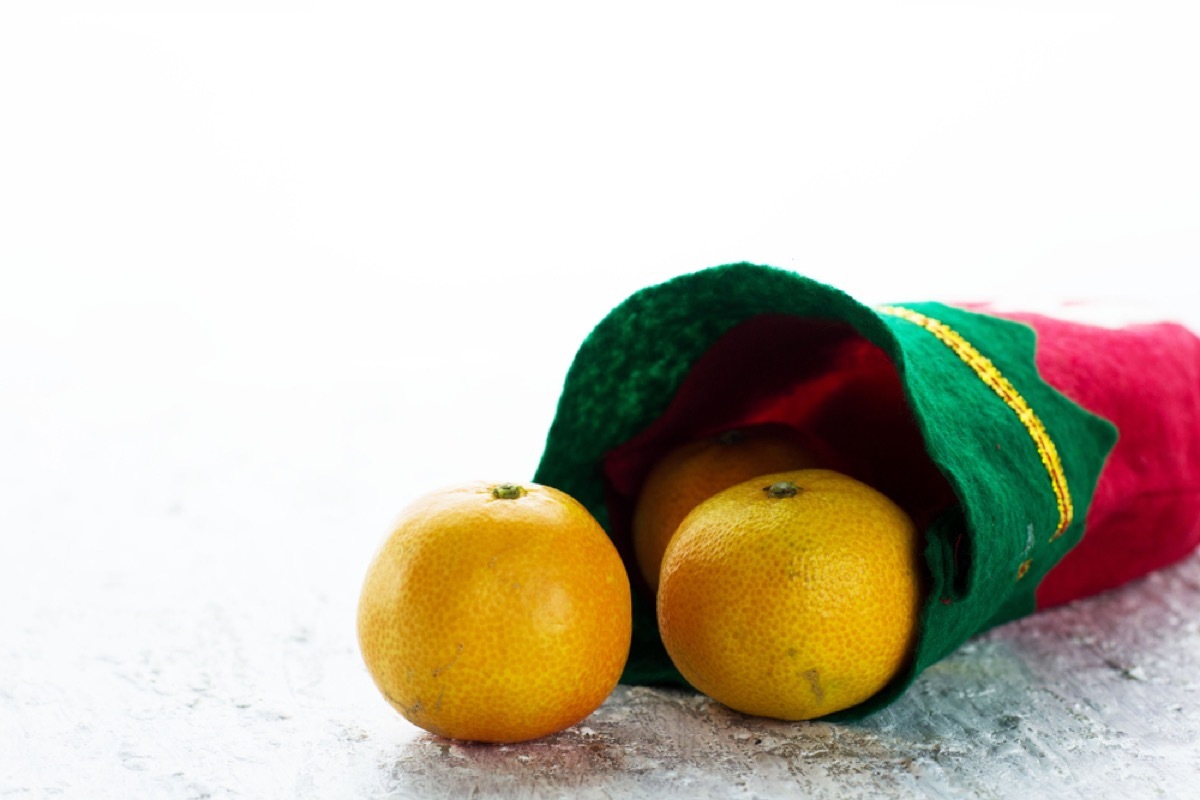 green and red christmas stocking with oranges in it