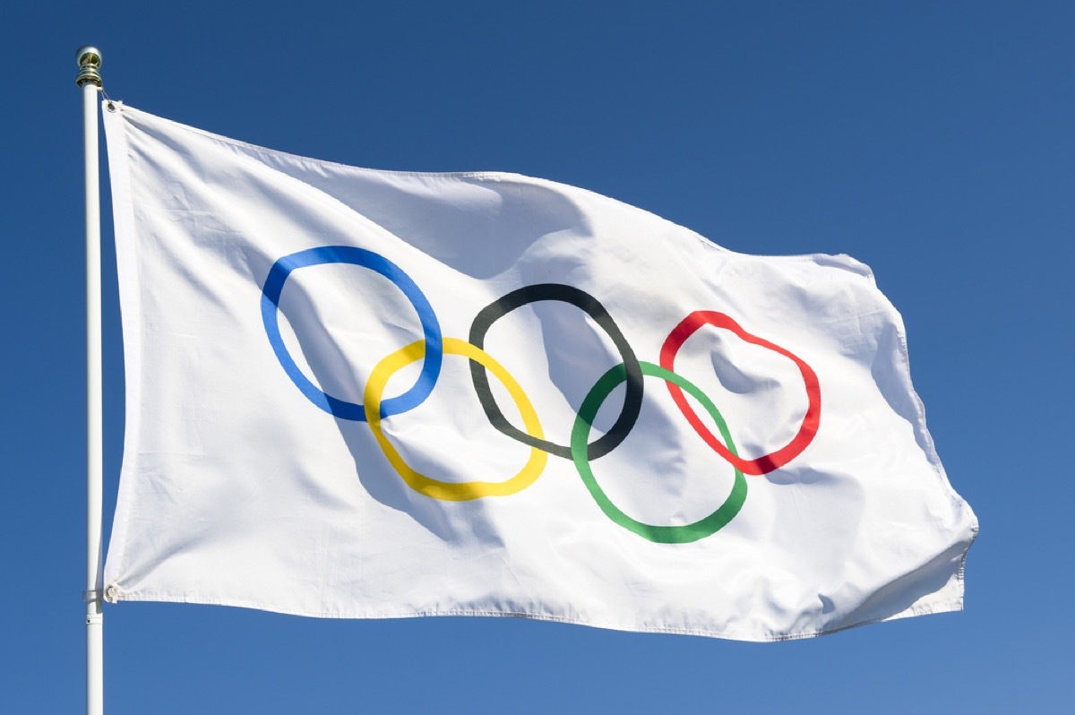 Olympic flag flying on flag pole