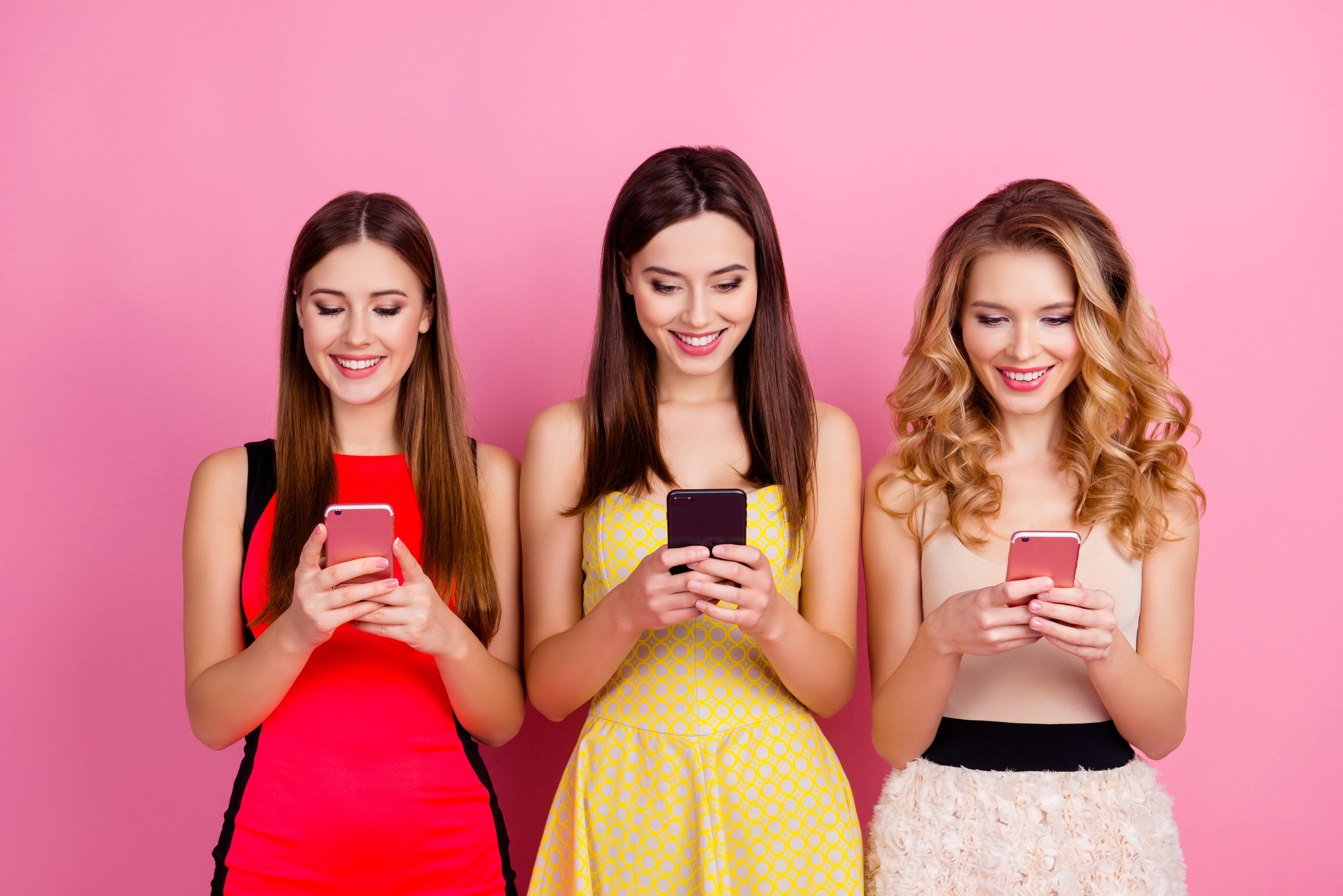 three girls on their phone