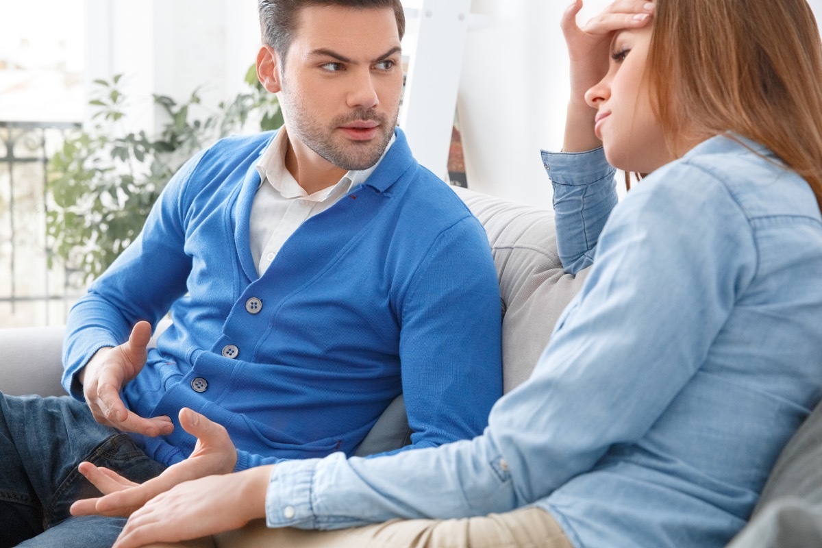 woman and man arguing on couch