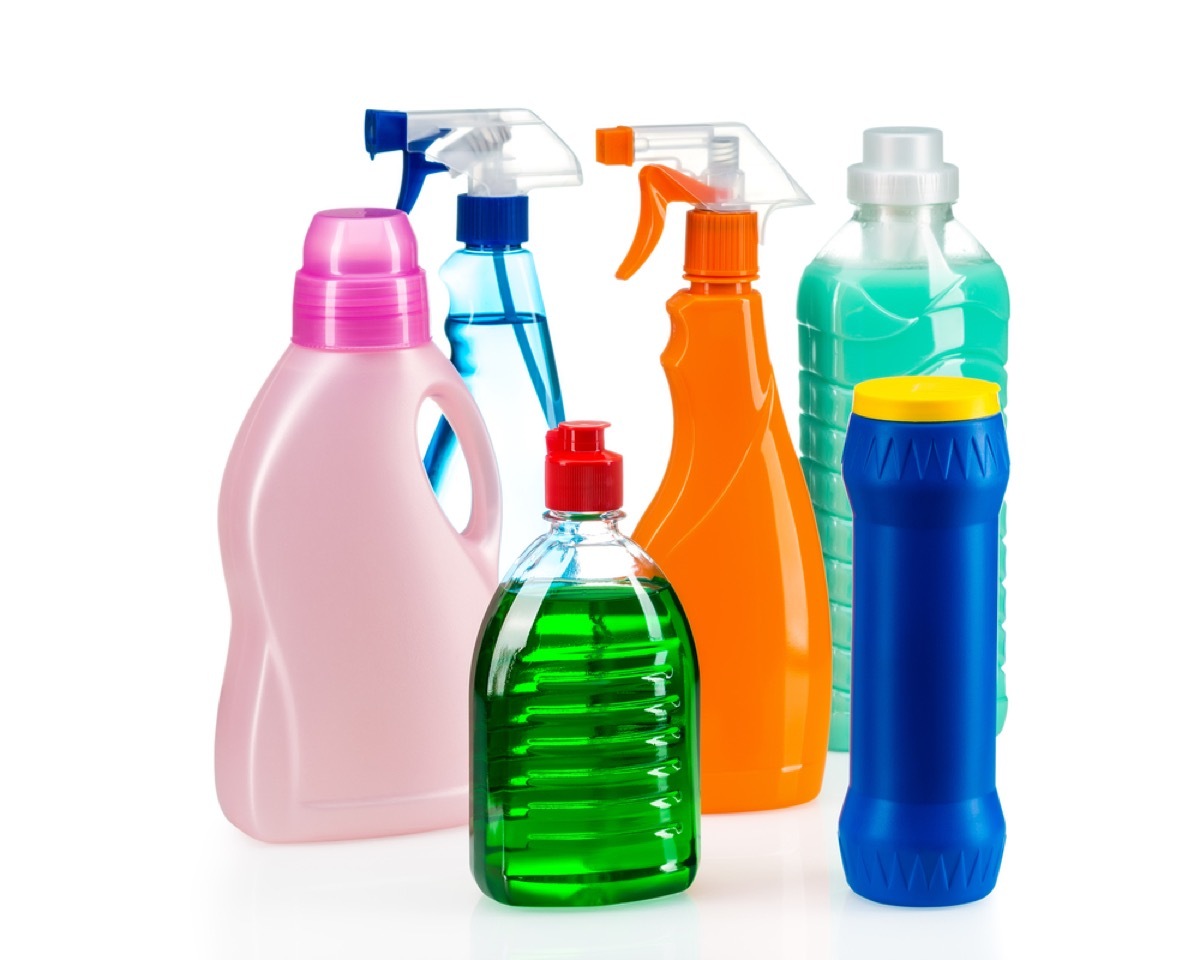 collection of colorful cleaning products in spray bottles and other containers