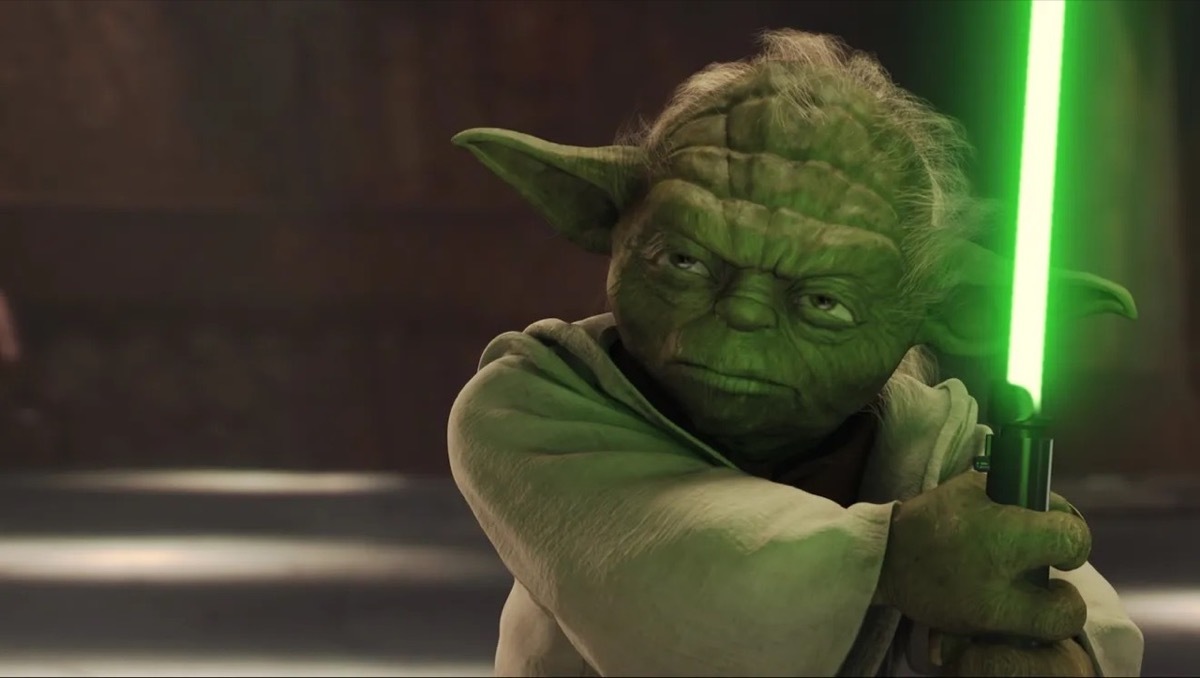 yoda holding a lightsaber