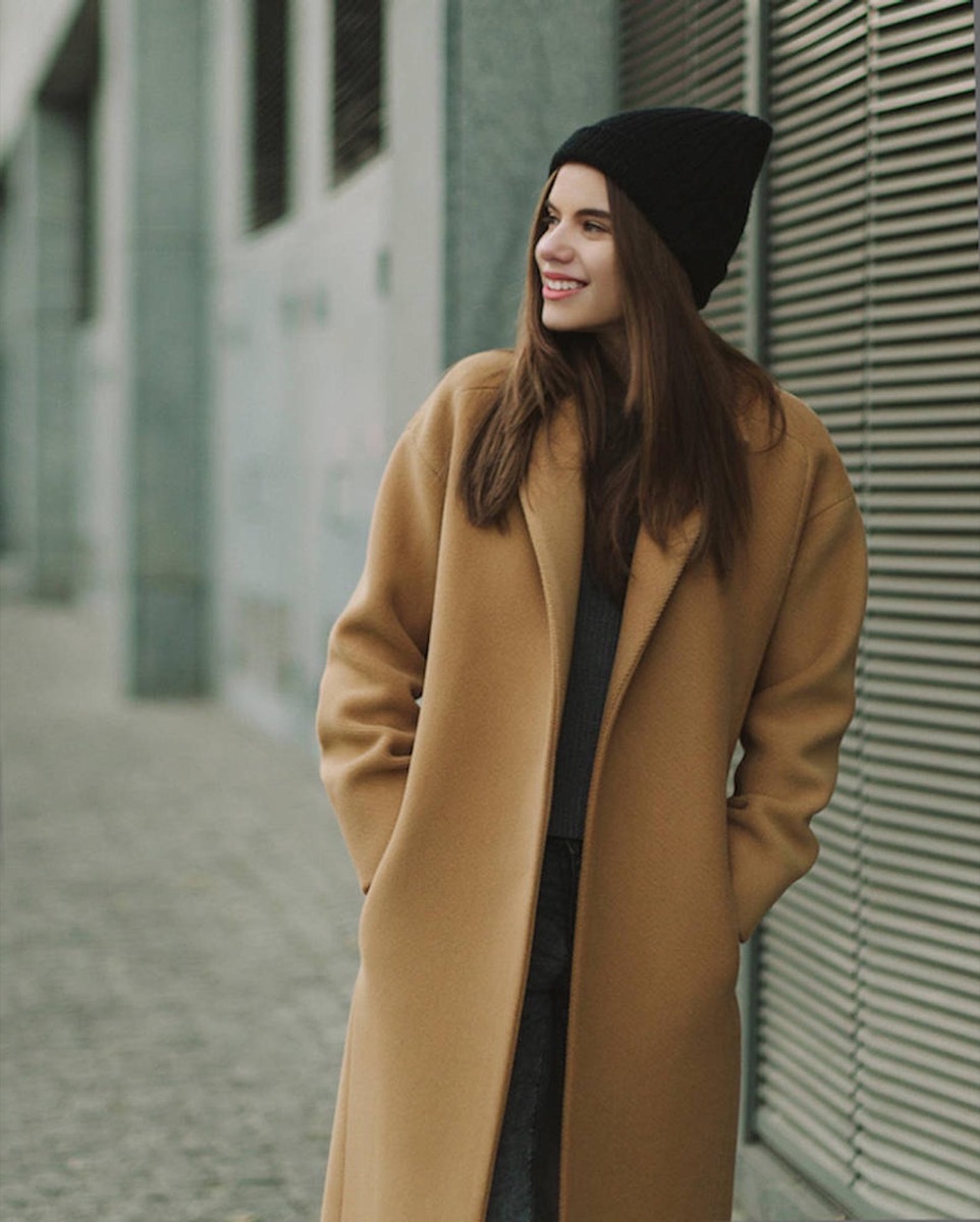 woman in camel coat