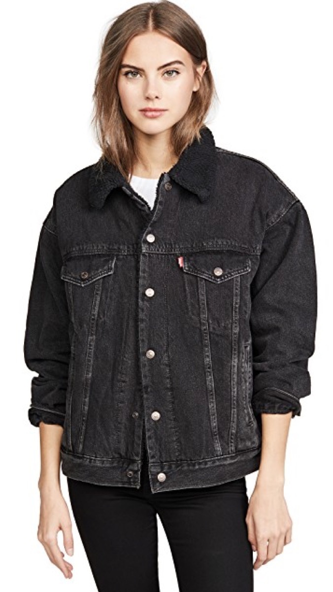 Woman wearing black denim sherpa lined jacket