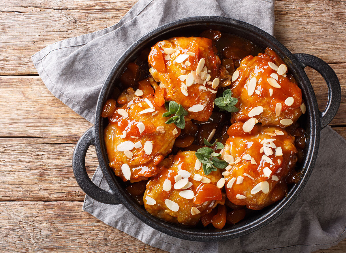 apricot chicken thighs in cast iron skillet with chopped almonds