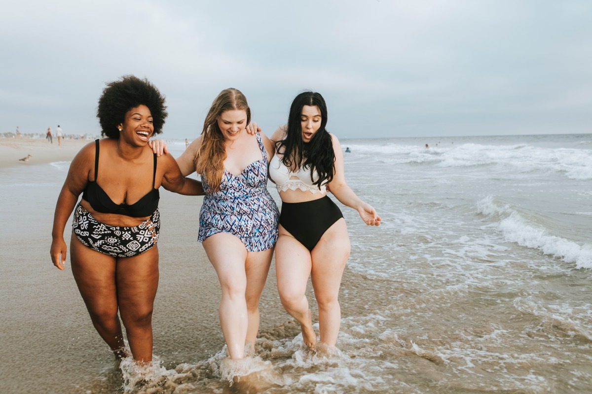 Friends enjoying a vacation on the beach in swimsuits