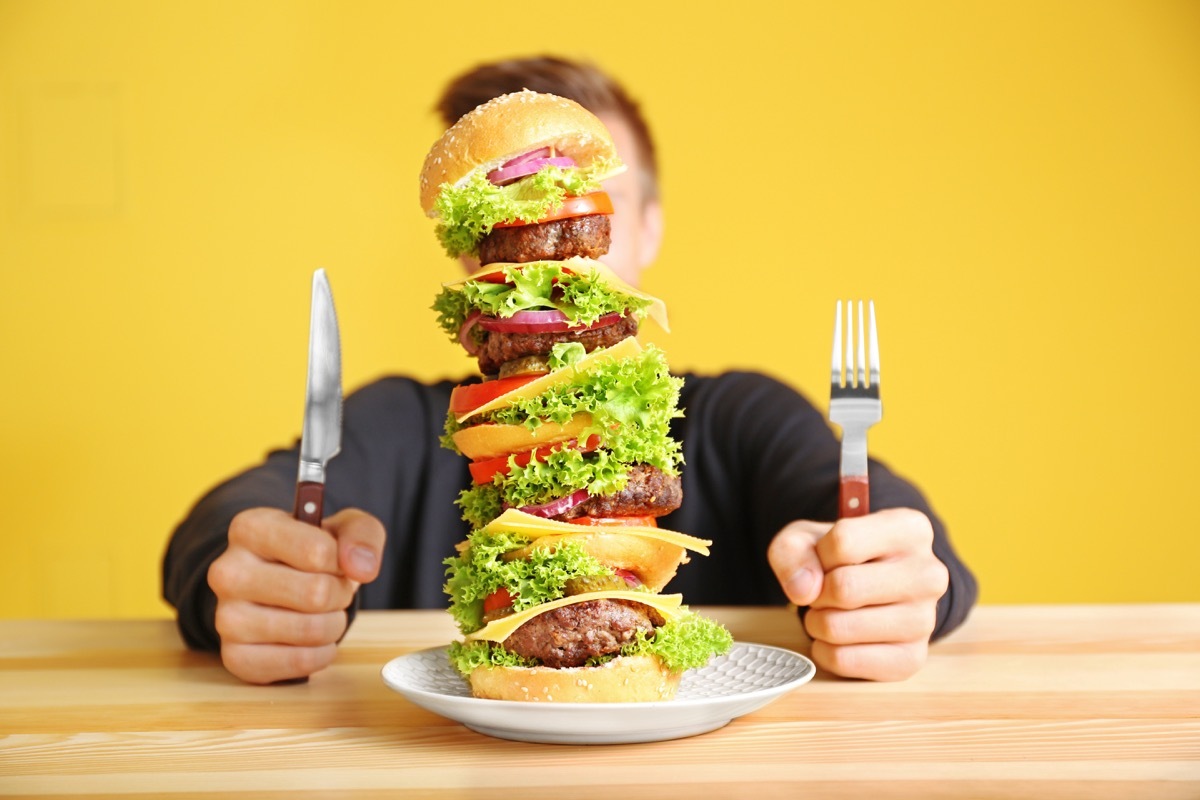 man eating huge burger 