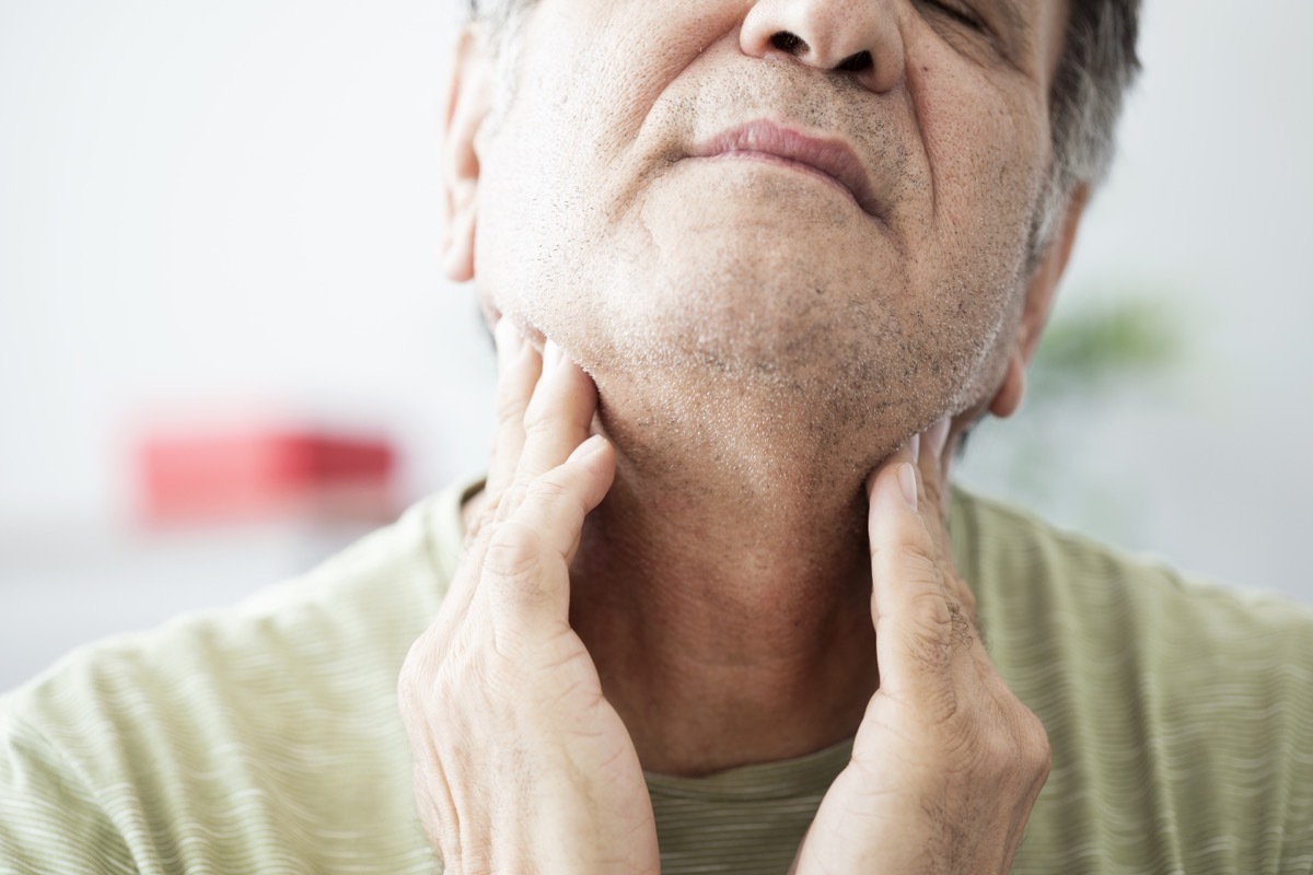 Old man feeling painful in the throat