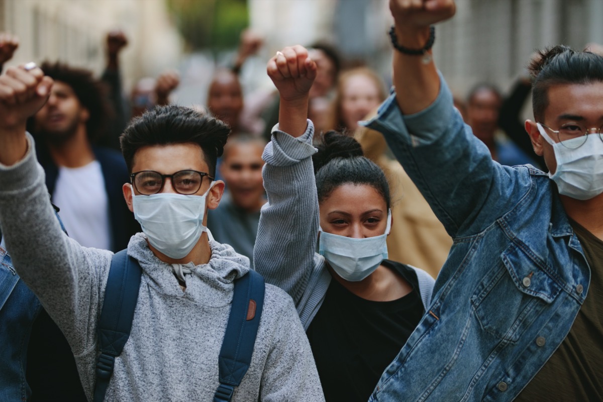 Group of people wearing face mask protesting and giving slogans in a ral