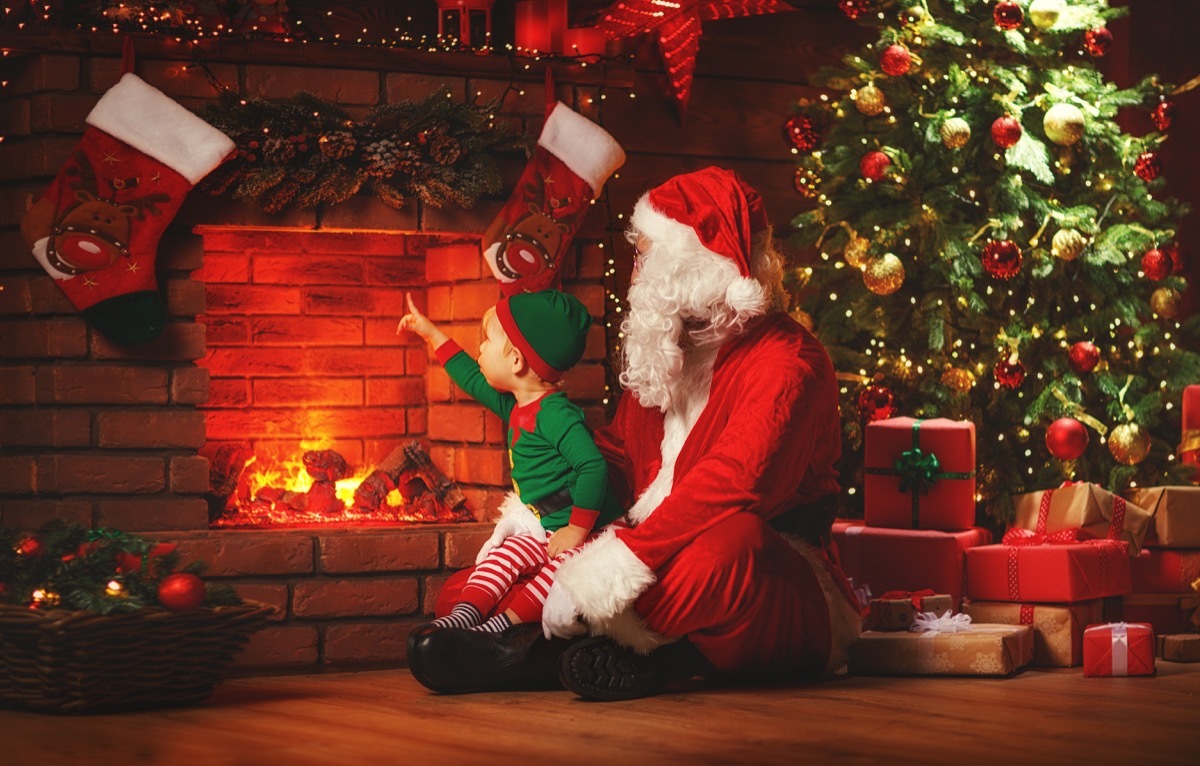 santa and elf in front of fireplace