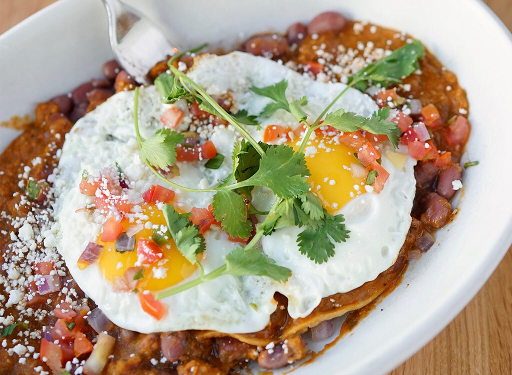 Fork dipping into true food kitchen huevos rancheros