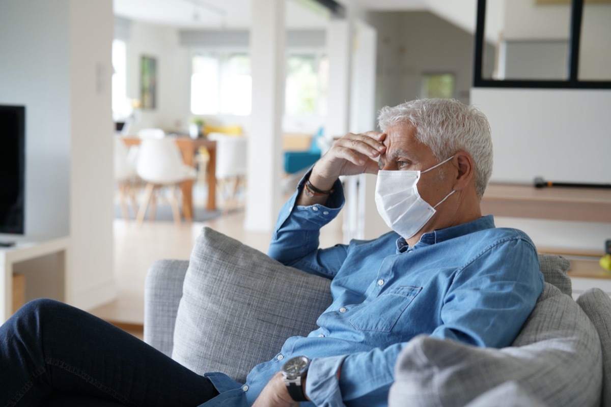 Senior man at home wearing protection mask