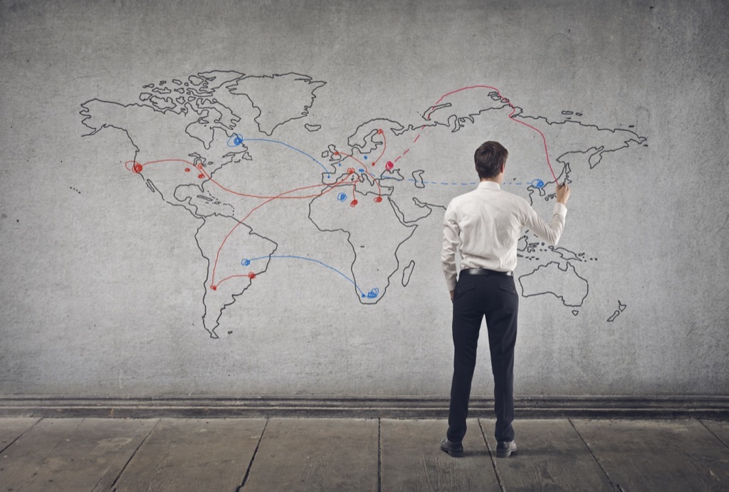 man drawing a map on a wall