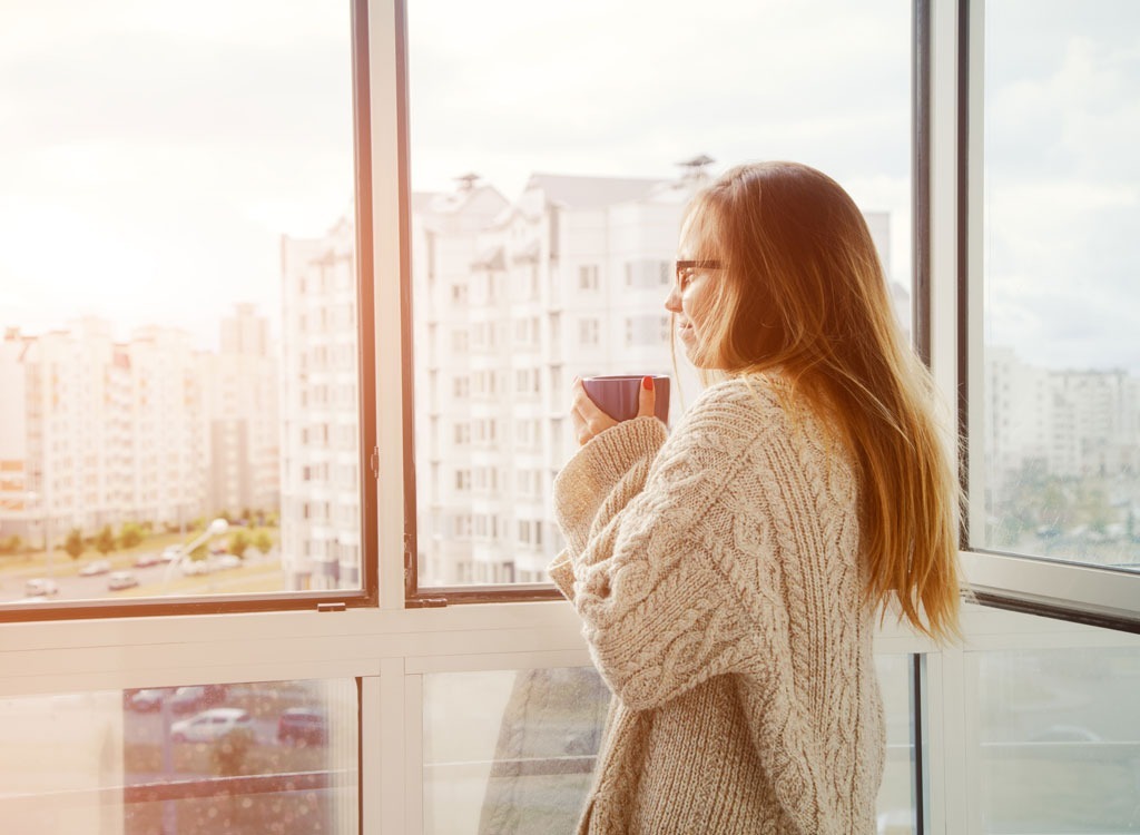 woman looking out window