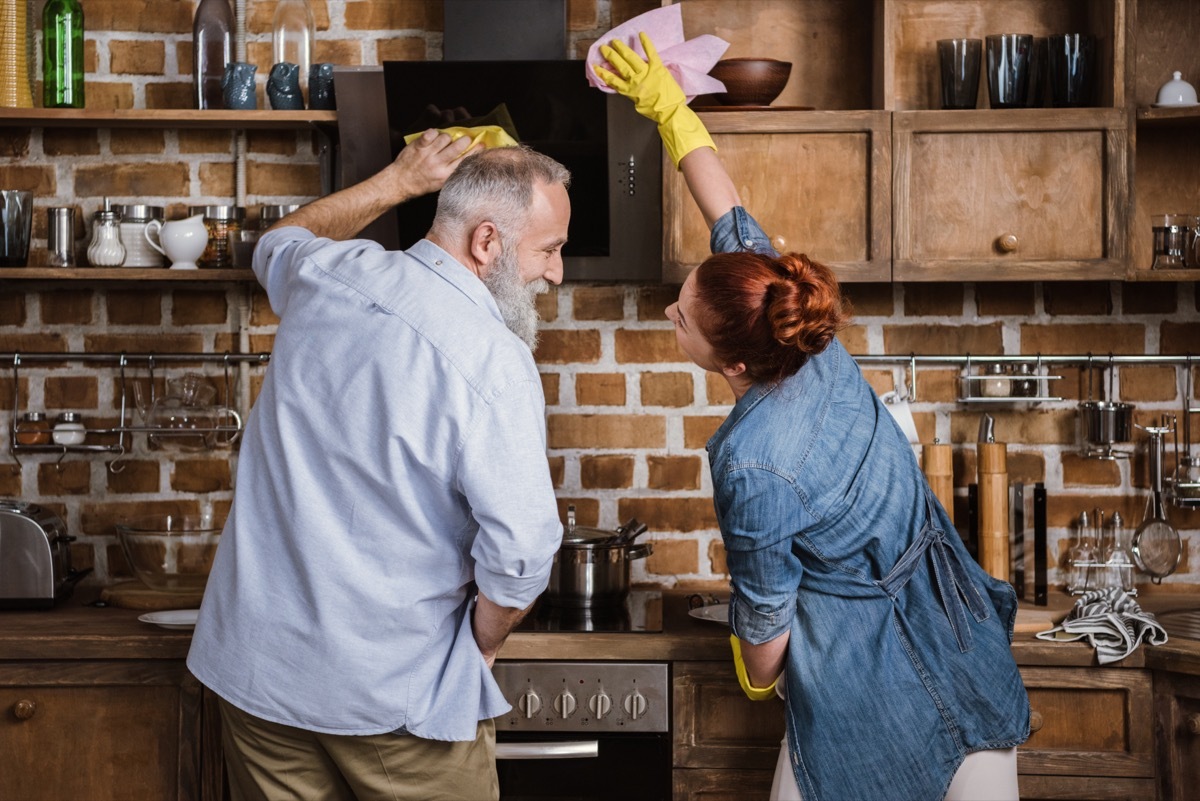 older couple cleaning kitchen